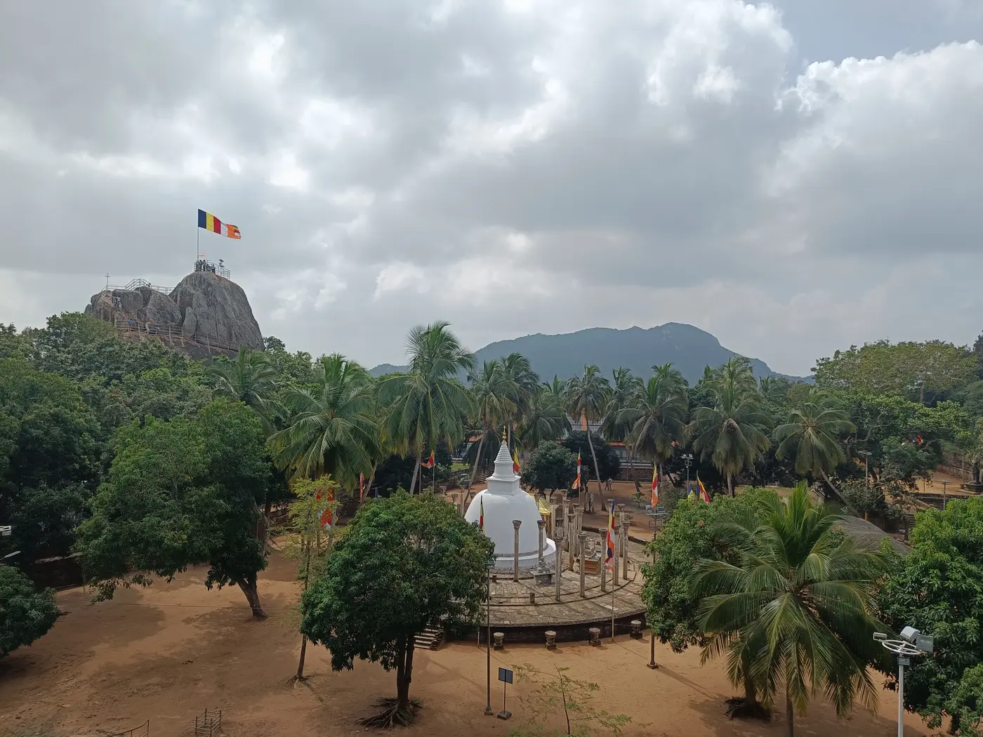 Historic Buddhist monuments surrounded by palms at Mihintale